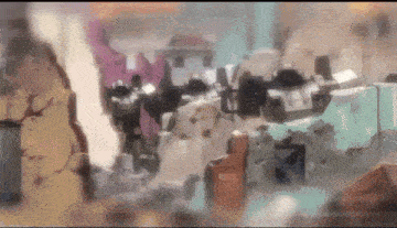 a blurred image of a building with a robot standing in the foreground