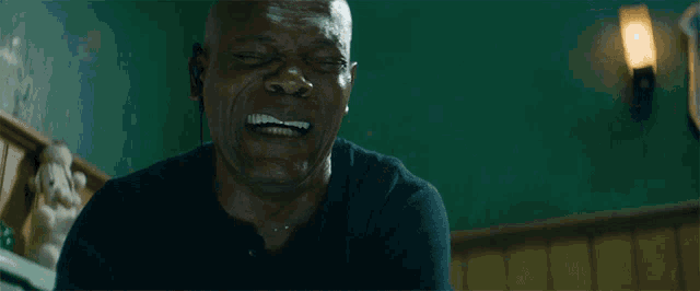 a man in a black shirt is crying with his mouth open
