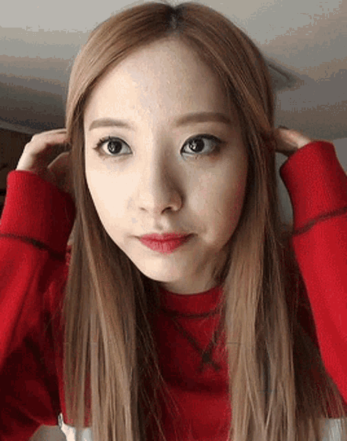 a close up of a woman wearing a red shirt