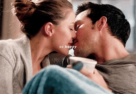 a man and a woman are kissing with the words so happy written above them