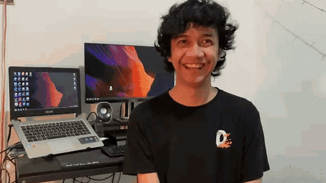 a man wearing a black t-shirt with the letter o on it