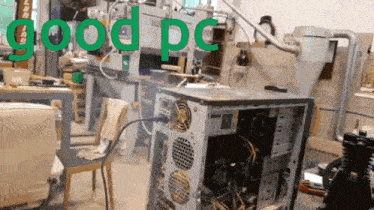 a computer sitting in a messy room with the word good pc written in green