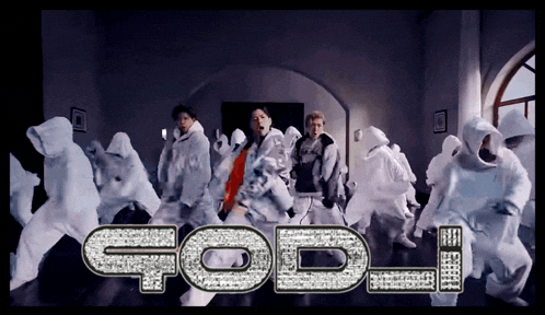 a group of people are dancing in a room and the word god is written in rhinestones