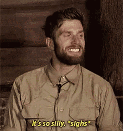 a man with a beard is smiling and saying it 's so silly sighs .