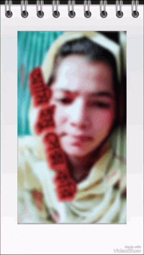 a blurred image of a woman 's face is displayed in a spiral bound notebook