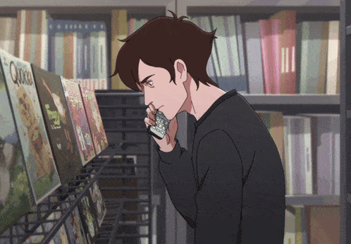 a man in a black sweater is looking at a book called quickie
