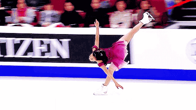 a figure skater is doing a trick in front of a citizen ad