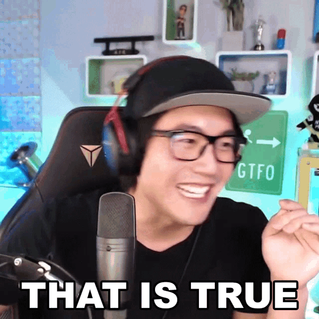 a man wearing glasses and headphones says that is true in front of a microphone