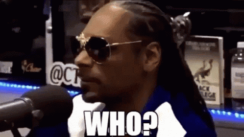 snoop dogg is wearing sunglasses and talking into a microphone while making a funny face .