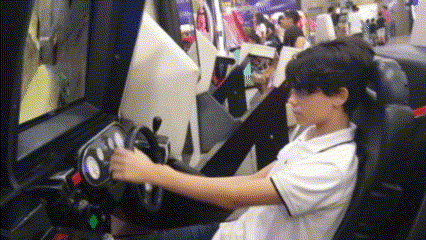 a boy is playing a video game in a car