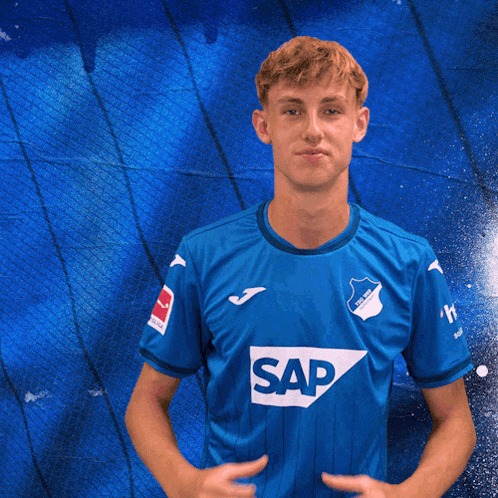 a boy wearing a blue shirt with the word sap on it