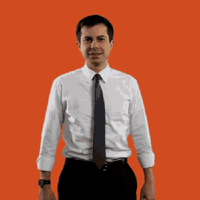 a man in a white shirt and tie is standing in front of a sign that says no