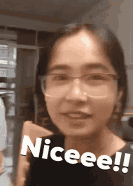 a woman wearing glasses says niceee !