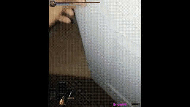 a person is playing a video game with a sword .
