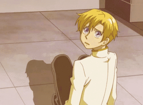 a yellow haired anime character with purple eyes is sitting on the floor