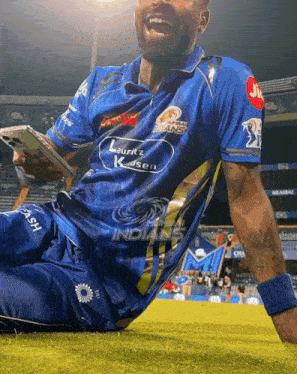 a man wearing a blue shirt that says indians