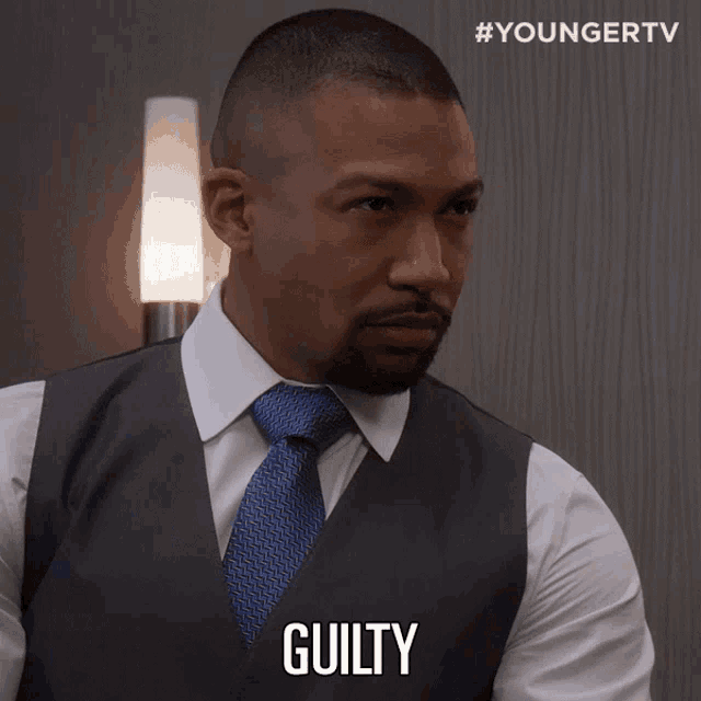 a man in a suit and tie says " guilty "
