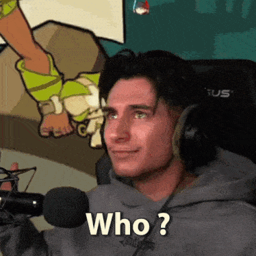 a man wearing headphones is sitting in front of a microphone and asking who