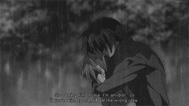 a black and white photo of a man and a woman hugging each other in the rain .