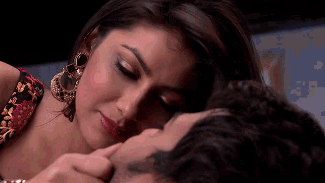 a close up of a woman kissing a man 's cheek