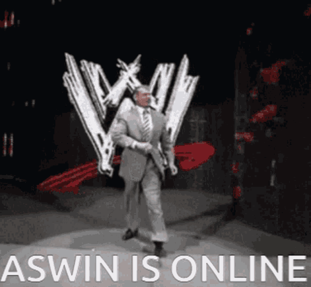 a man in a suit and tie is dancing in front of a w logo and the words aswin is online