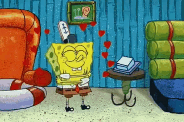spongebob squarepants is standing in a living room with hearts on the wall behind him .