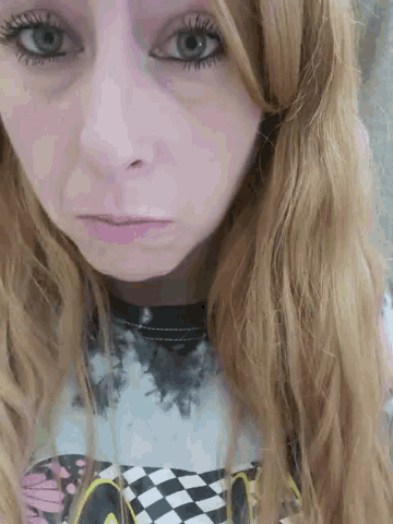 a close up of a girl 's face with a checkered shirt
