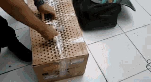 a man is wrapping a box that says xbox 360