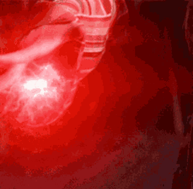 a close up of a person 's face in a red light