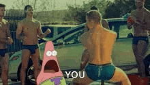 patrick star is standing in front of a group of men in underwear .
