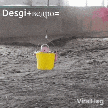 a baby is hanging in a yellow bucket with the words desgi + bedpo written above it