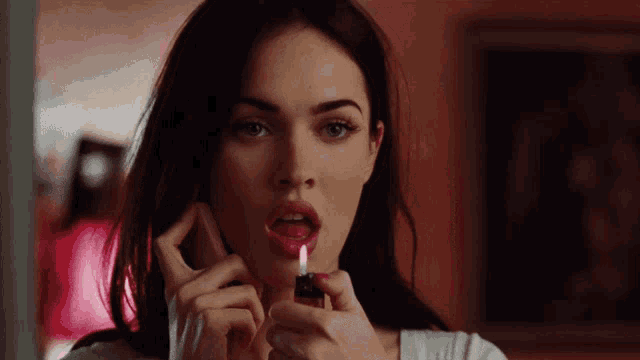 a close up of a woman lighting a cigarette