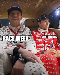 two race car drivers are sitting in the back seat of a car and one of them is wearing a shirt that says race week