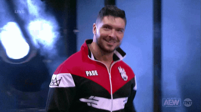 a man wearing a red white and black jacket with the word pade on the front