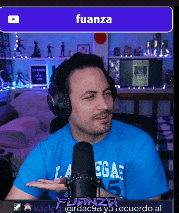 a man wearing headphones and a blue shirt with the word fuanza on the top