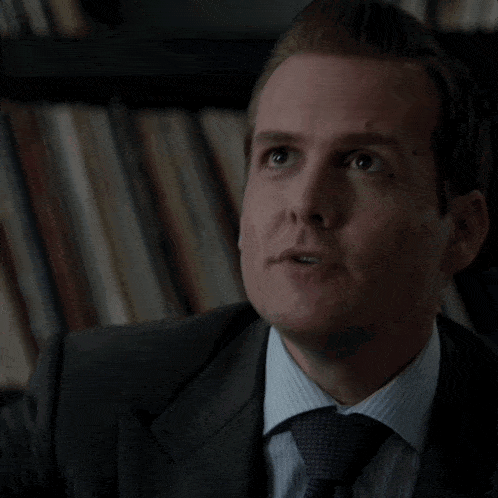 a man in a suit and tie is looking up