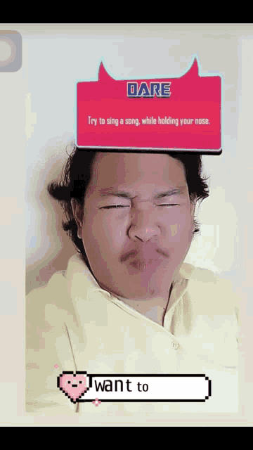 a man is singing a song while holding his nose with a dare sign above his head
