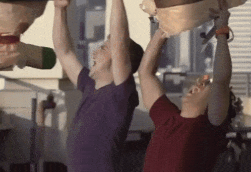 a man in a purple shirt is hanging upside down