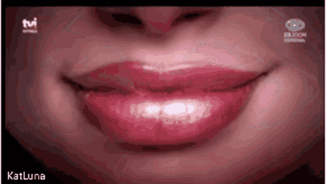 a close up of a woman 's lips with pink lipstick on a tv screen .