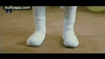 a close up of a person 's feet wearing white socks