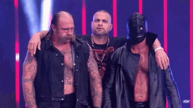 a group of men standing next to each other with the aew logo on the bottom right