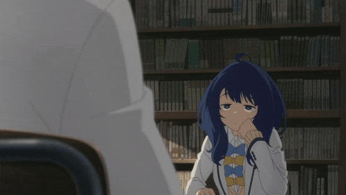 a girl with blue hair is sitting in front of a bookcase
