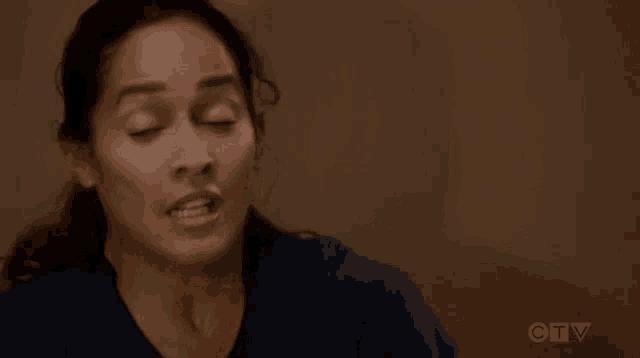 a close up of a woman 's face with her eyes closed and her mouth open .