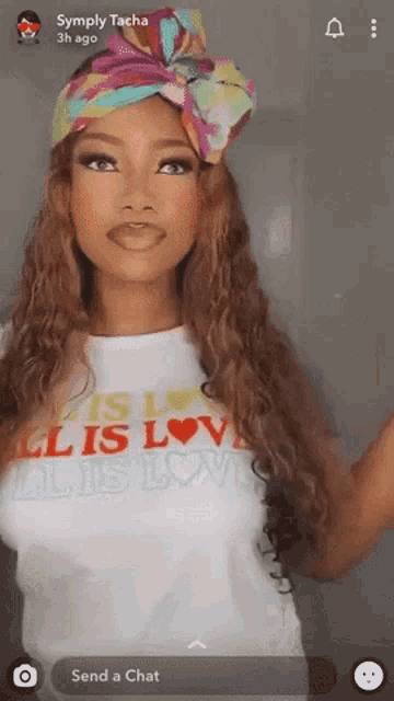 a woman wearing a t-shirt that says " all is love "