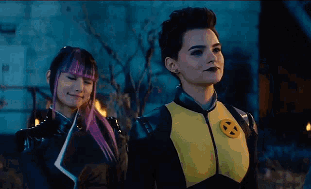 two women are standing next to each other and one is wearing a x-men costume