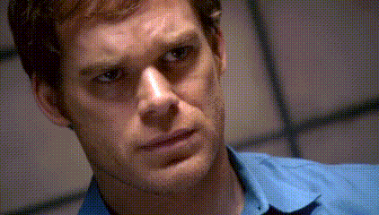 a man in a blue shirt looks at the camera