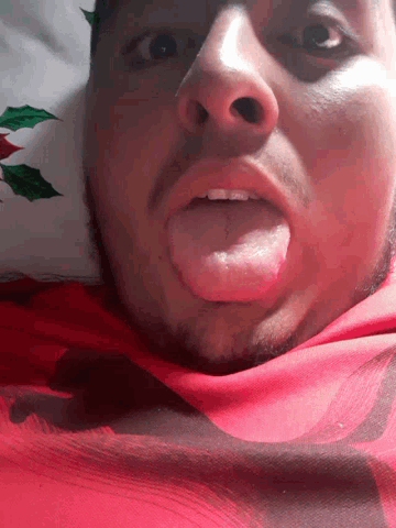 a close up of a person 's face with their tongue out
