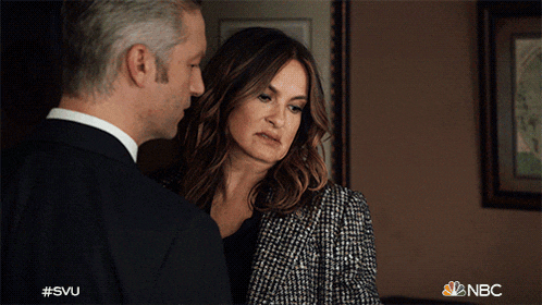 a man and a woman are standing next to each other and the nbc logo is visible