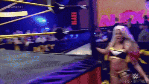 a woman in a wrestling ring with a sign that says ' a ' on it