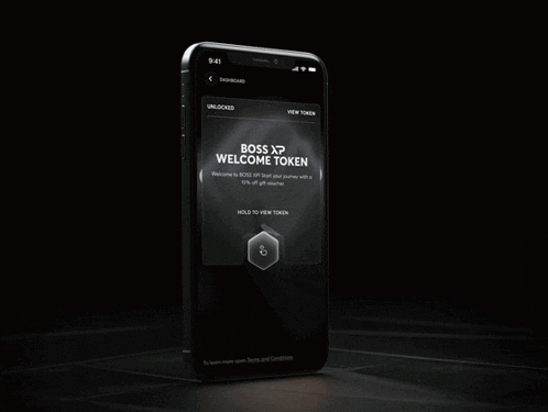 a cell phone with a boss xp welcome token on it
